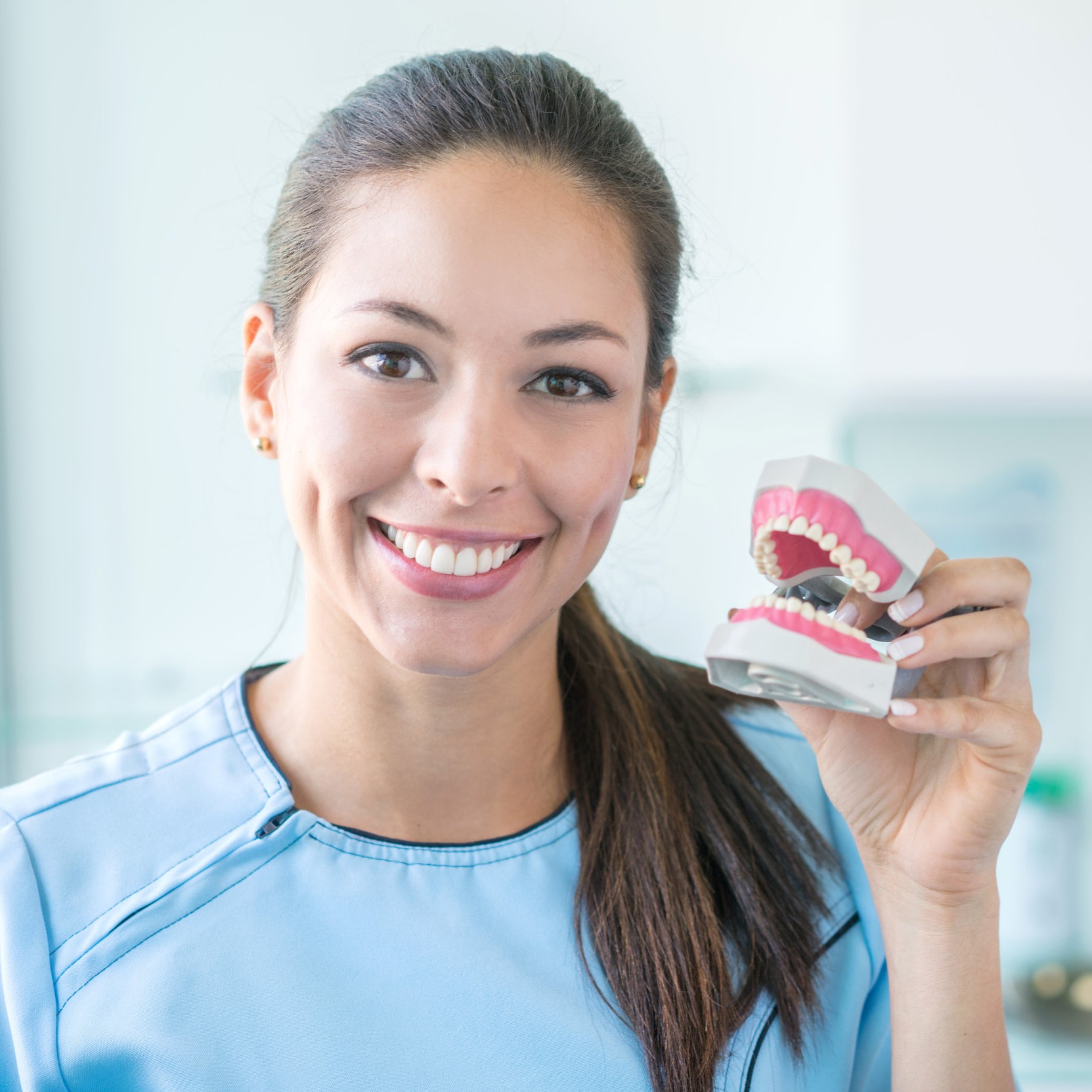 Dentist holding a denture
